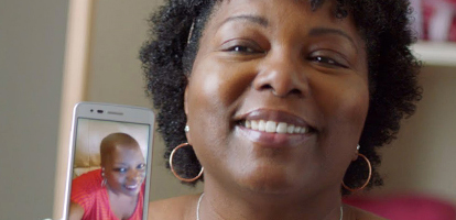image of a women holding up an image of herself from treatment