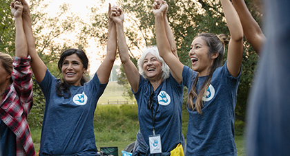 image of a group of women holding hands cheering