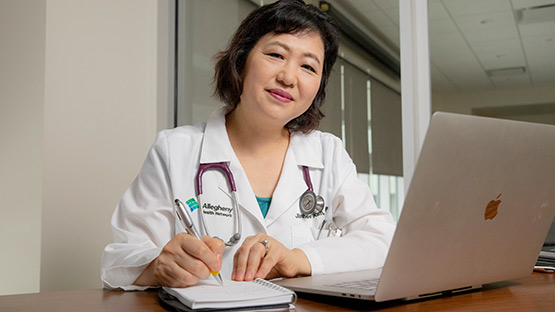 Doctor on laptop advising a patient during a video visit