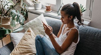 young woman using her smartphone to fill out evisit questionnaire on MyChart
