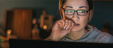woman using laptop for 24/7 Virtual Urgent Care telehealth video visit
