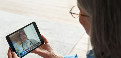 woman using her tablet to have a video visit with her AHN doctor