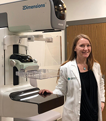 ahn fellow smiling in front of breast imaging machine