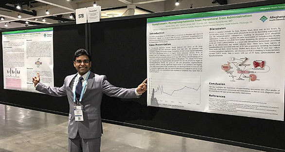 Fellow pointing at research posters