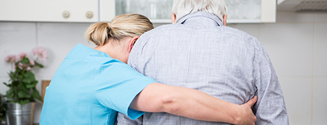 image of a nurse helping a senior citizen walk