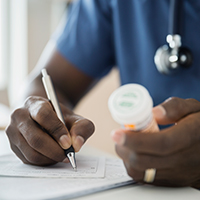 image of a doctor writing a prescription