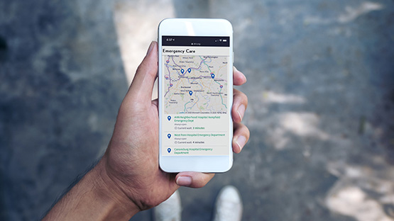 image of a person holding a phone showing the locations of AHN Facilities