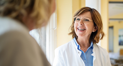 AHN provider smiling as she speaks with her patient