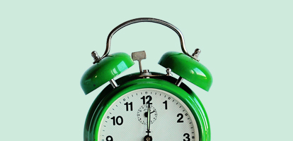 green alarm clock about to ring
