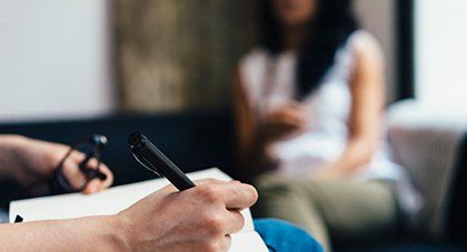 image of a doctor writing a personalized treatment plan for a patient