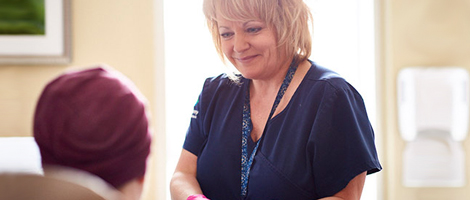 image of a nurse helping a patient at the AHN After Hours Oncology Clinic