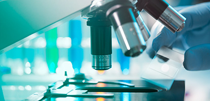 image of a researcher looking through a microscope