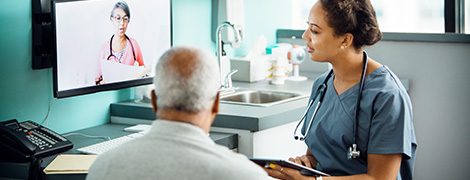 image of a doctor and patient consulting with another doctor over telemedicine