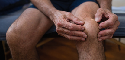 image of a man holding his knee