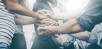 image of a people joining hands together
