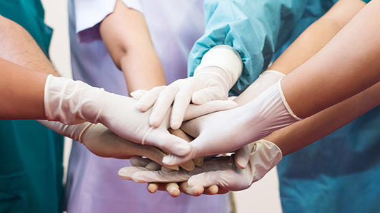 image of a chronic care team joining hands