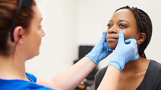 image of an AHN dermatologist examining patient