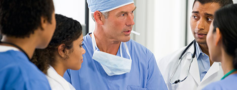 image of a surgeon teaching a group of fellows