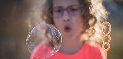 image of a woman blowing bubbles