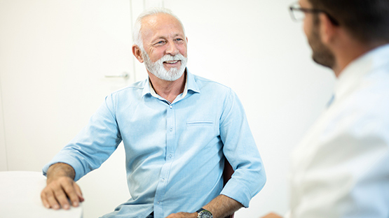 man smiling as he discusses his care options
