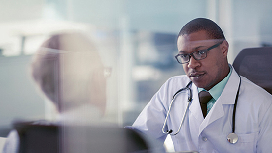 AHN doctor smiling as he speaks with a patient