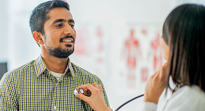 Doctor using a stethescope on a patient