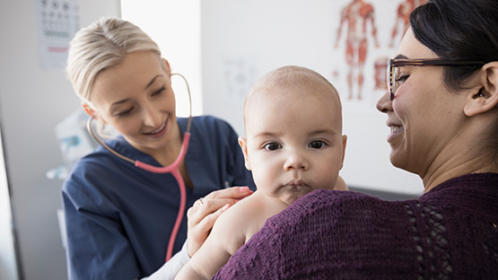 image of a doctor listening to a baby breathing
