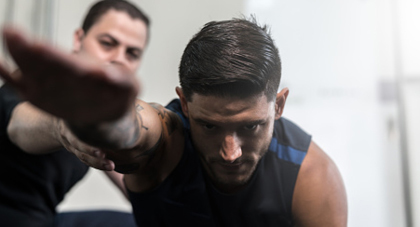 physical therapist helping a patient with shoulder injury