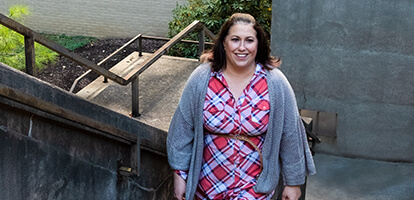 AHN patient Amanda smiling as she walks up stairs no longer suffering from back pain